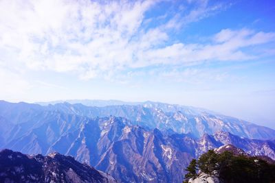 Scenic view of mountains against cloudy sky