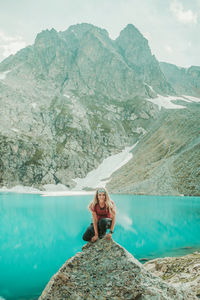 Man standing on rock by mountain