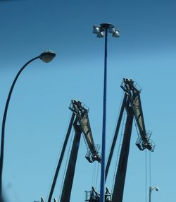 Low angle view of street light against clear blue sky