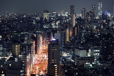 Aerial view of illuminated buildings in city at night