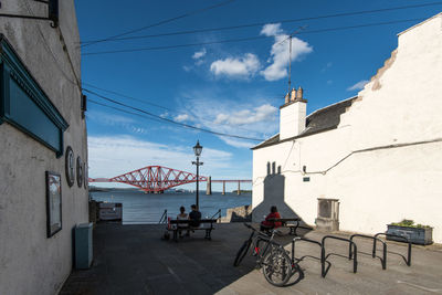 Bicycle on bridge against buildings in city