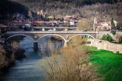 Arch bridge over river in town