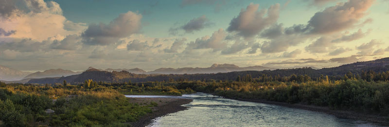 Scenic view of river amidst mountains against sky