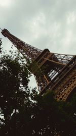 Low angle view of tower against cloudy sky