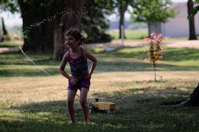 Full length of a girl standing on grass