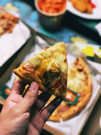 Close-up of hand holding ice cream in plate