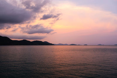 Scenic view of sea against romantic sky at sunset