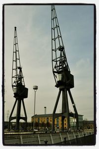 Low angle view of crane against sky