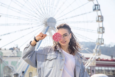 Portrait of smiling young woman in amusement park