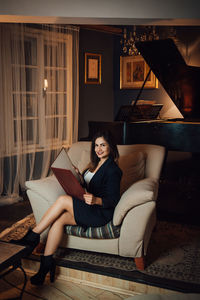 Woman sitting on sofa at home