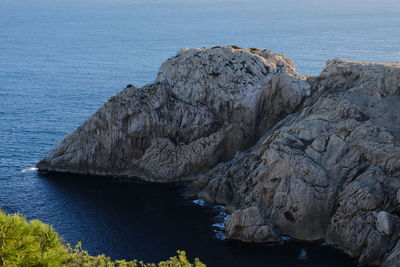 Rock formations by sea against sky