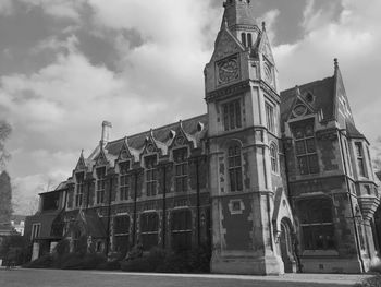 Low angle view of old building against cloudy sky