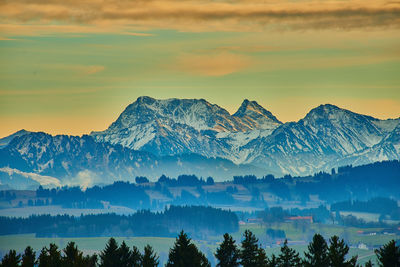 Scenic view of snowcapped mountains against sky during sunset