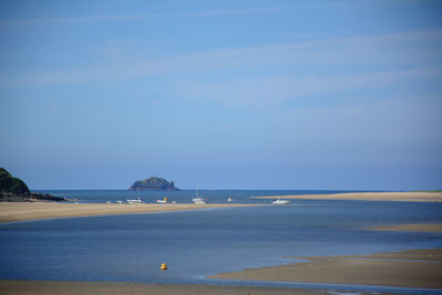 Scenic view of sea against blue sky