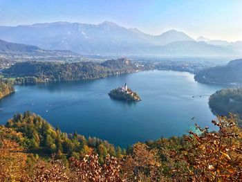 High angle view of lake and mountains against sky