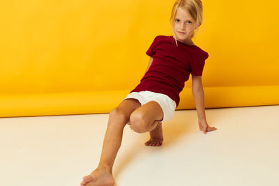 Portrait of young woman exercising on floor