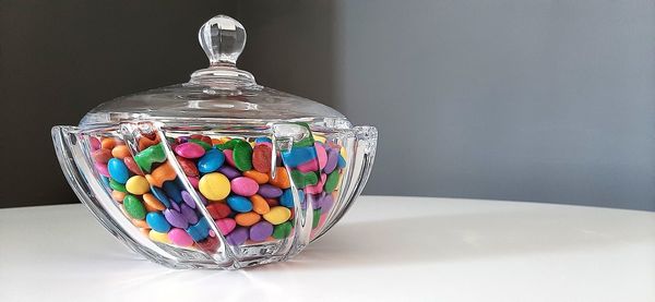 Close-up of multi colored glass on table