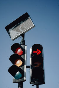 Low angle view of road sign against clear sky