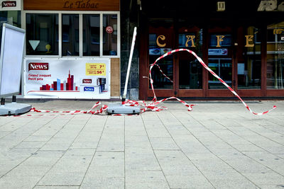 Text on footpath against building in city
