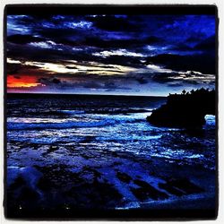 Scenic view of sea against cloudy sky