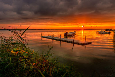Scenic view of sea against orange sky