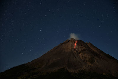 Low angle view of mountain against sky at night