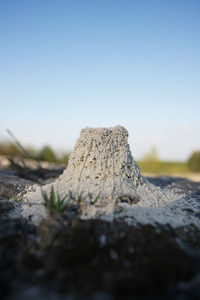 Surface level of rocks against clear sky