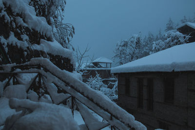 Snow covered trees against sky