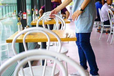 Low section of people standing on chair