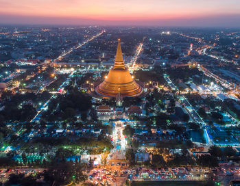 Aerial view of illuminated buildings in city at night