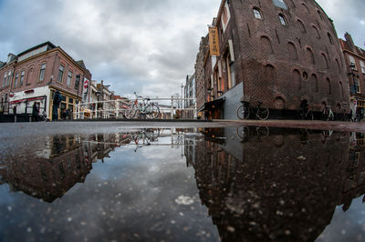 Reflection of building in puddle