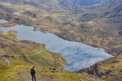 Rear view of man walking on mountain