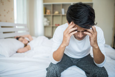 Rear view of couple sitting at home