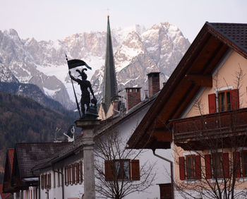 Buildings against mountain range during winter