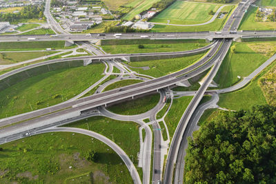 Cars moving on transport road junction in city, aerial view