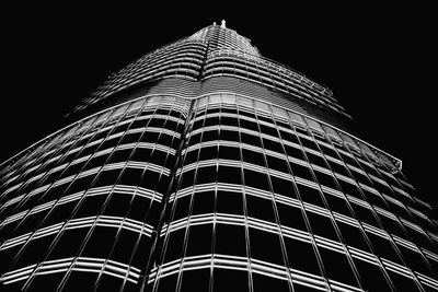 Low angle view of illuminated skyscraper against sky at night