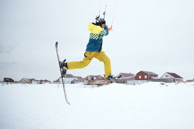 Low angle view of man skiing on snow against sky