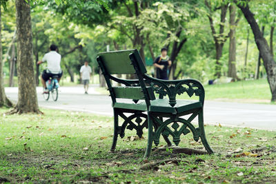 Crowd of people exercising, running and riding bicycle in the park on a beautiful sunday morning