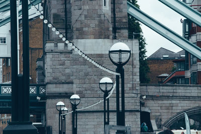 Street light against bridge in city