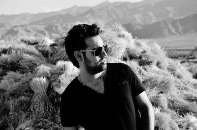 Young man wearing sunglasses standing outdoors