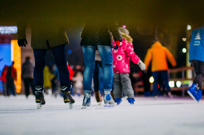 People ice skating in city