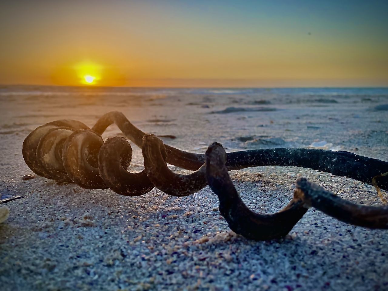sunset, sea, sky, water, beach, land, wave, nature, ocean, horizon over water, horizon, sand, no people, beauty in nature, tranquility, scenics - nature, sunlight, tranquil scene, sun, outdoors, metal, shore, rusty, cloud, reflection, coast