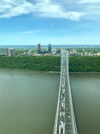 View of bridge over river against cloudy sky