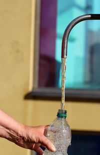 Close-up of water flowing into bottle