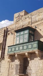 Low angle view of old building against sky