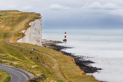 Beachy head white chalk cliffs and red-white lighthouse, south downs, east sussex coast, uk