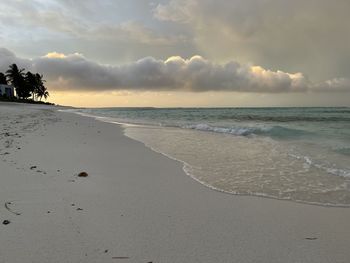 Scenic view of beach against sky during sunset