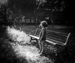 Full length of woman sitting on tree stump