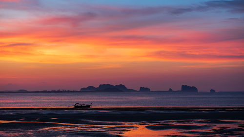 Scenic view of sea against romantic sky at sunset