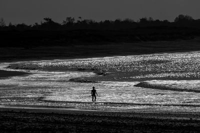 Silhouette men standing on landscape against sky